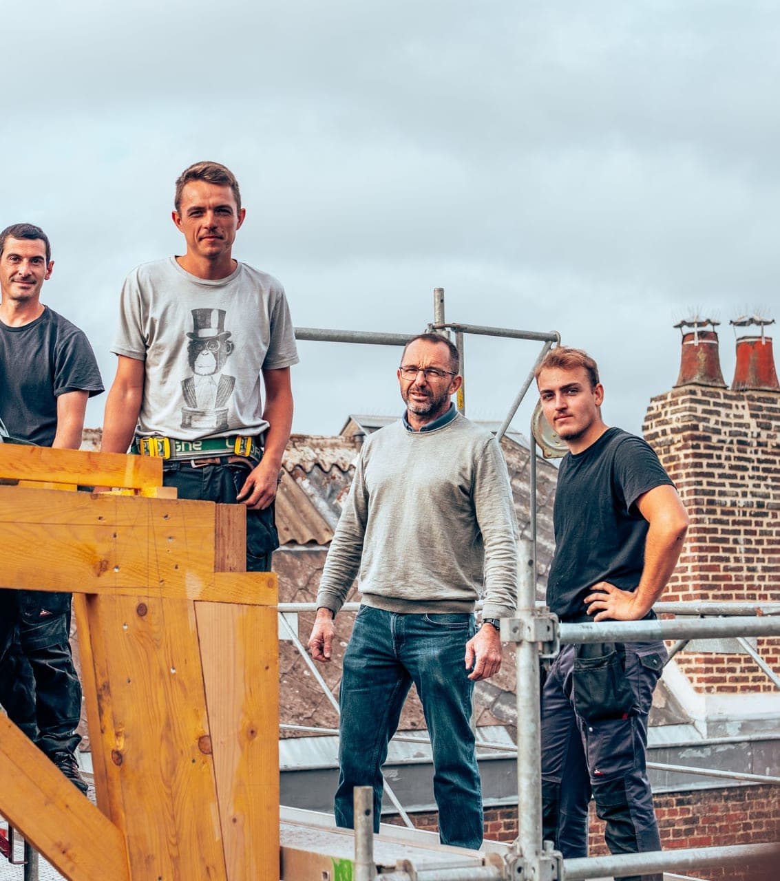 Quatre compagnons de l’entreprise sur l’échafaudage d’un chantier de charpente